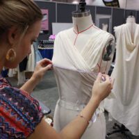 A woman working on an outfit in a store.