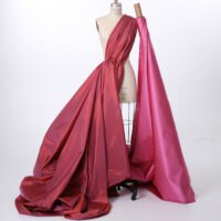 A mannequin wearing a dress with pink fabric.