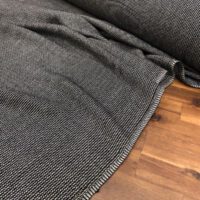 A close up of the fabric on a wooden floor