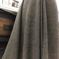 A gray fabric with a pattern of squares.
