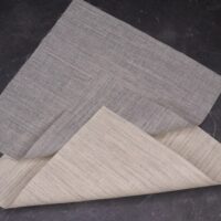 A folded sheet of paper with a napkin on top.