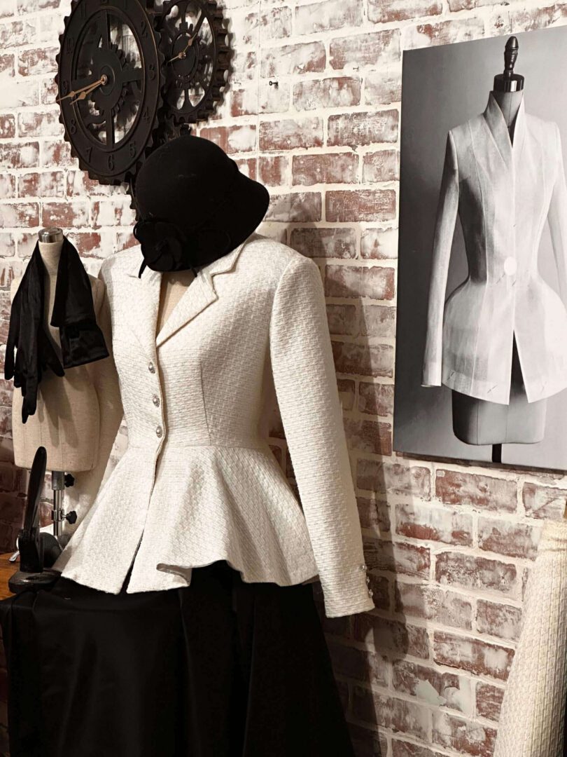 A white jacket is hanging on the wall.
